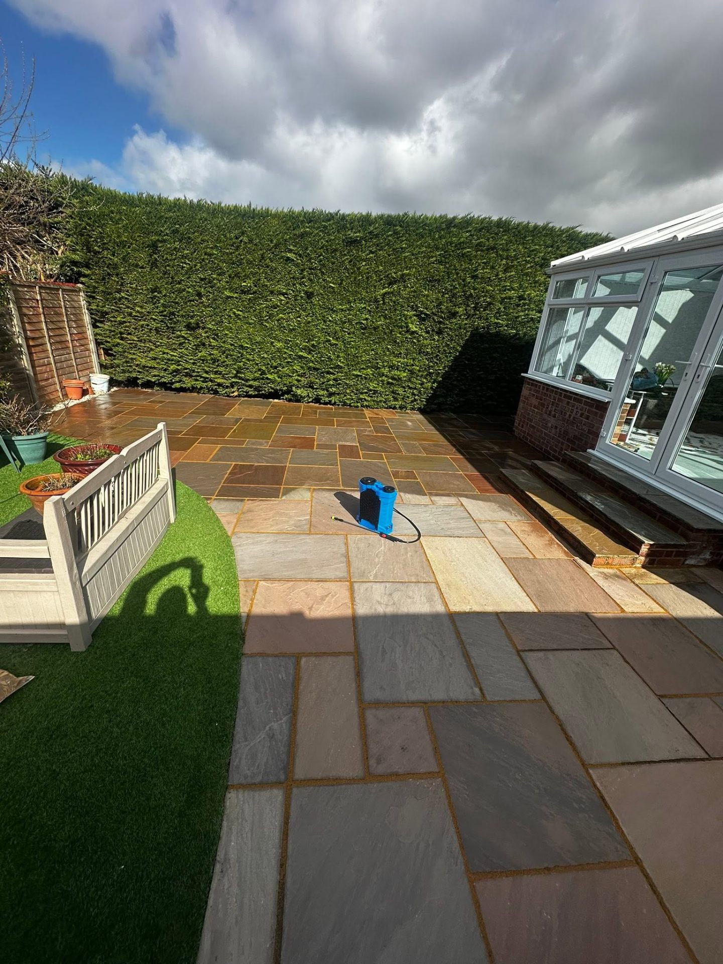 Sandstone patio cleaned with softwash treatment, Dorset garden